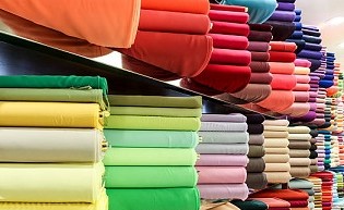 bolts of plain colored fabrics